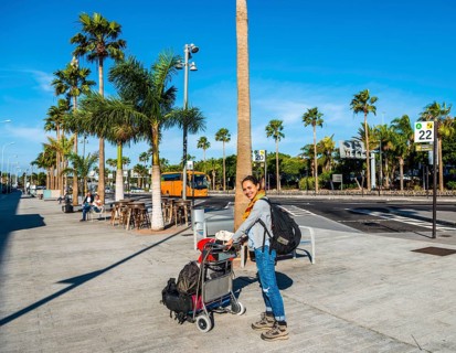 Young woman with trolley with luggage