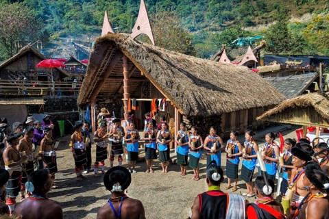Naga tribes people in front of a traditional house