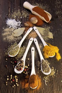 Various dried spices on small spoons