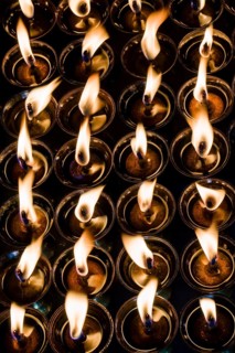 Tibetan butter lamps with burning flames