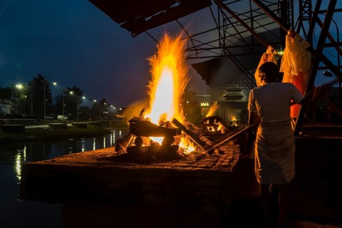Cremation of a dead body at the burning ghats at night