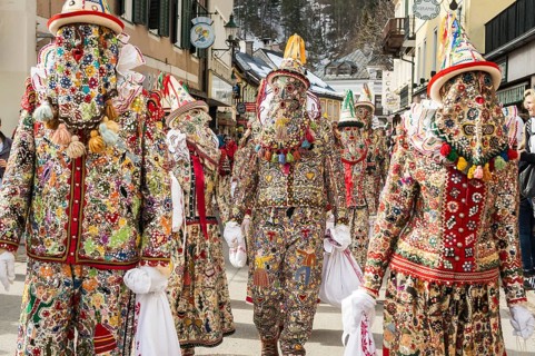 Ausseer Flinserl disguised people in costume with face masking or Gugl and hat