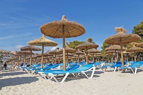 Beach with deck chairs and parasols