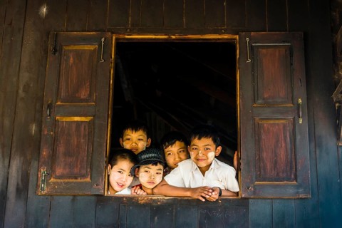 School children look curiously out of the window