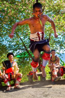 Naga tribal man in traditional outfit performing a warrior dance