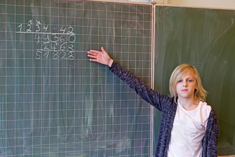 Student calculating on the blackboard