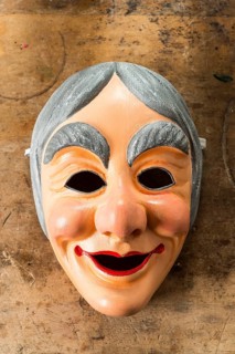 Painted wooden mask on a workbench