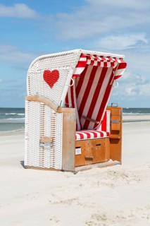 Beach chair with red heart on the beach