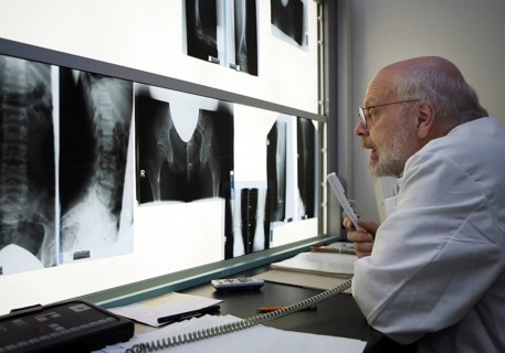 Radiologist evaluates x-ray photographs