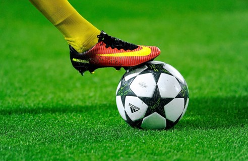 Nike football shoe on Adidas Champions League Ball