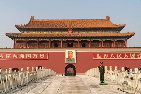 Guardsman in front of portrait of Mao Zedong