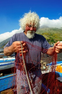 Fishermen repair nets at Scari Beach