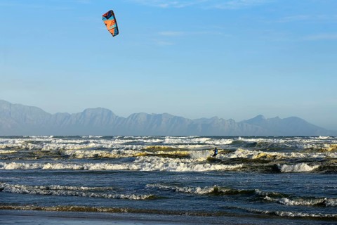 Kitesurfers at high waves