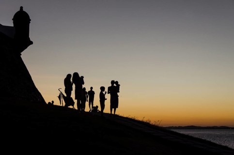 Adults and children at sunset