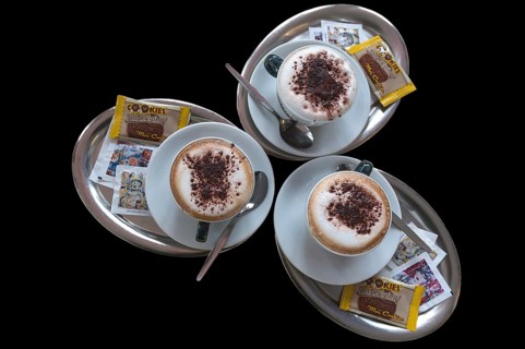 Three cappuccino on silver trays
