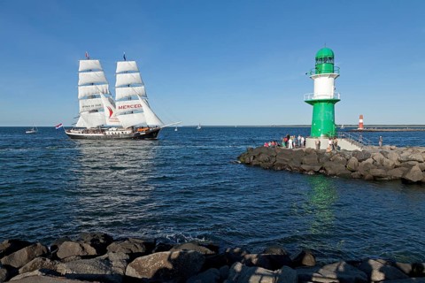 Lighthouse with sailing boat Mercedes at back