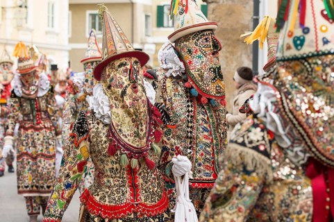Ausseer Flinserl disguised people in costume with face masking or Gugl and hat