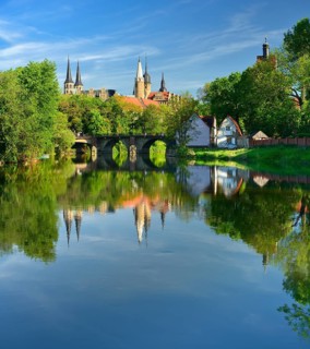 Merseburg Cathedral and Merseburg Castle are reflected in the River Saale