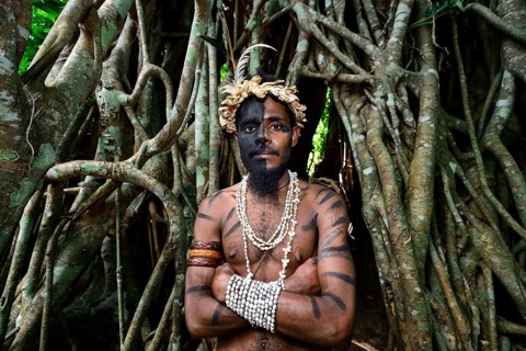 Tribal warrior in front of the roots of the banyan tree
