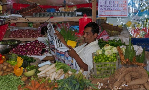 Seller reading newspaper