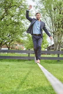Manager balancing on slackline