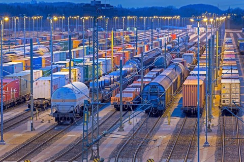 Parked freight cars on tracks at night