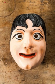 Painted wooden mask on a workbench
