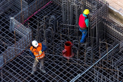 Construction workers processing reinforcing steel for reinforced concrete ceiling