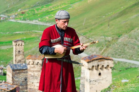 Georgian musician of a folkloric group playing Panduri