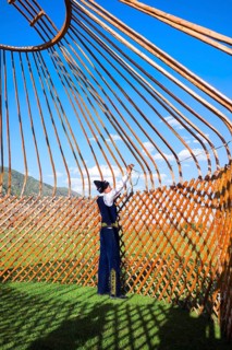 Kazakh men putting up a yurt
