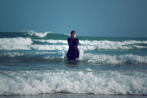 Woman in black dress with mask
