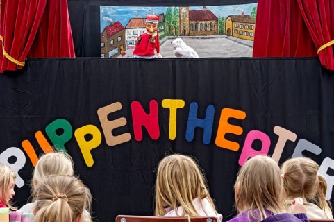 Children watching the puppet theater