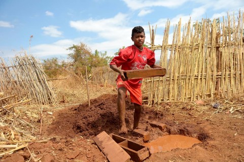 Teenager manufacturing bricks