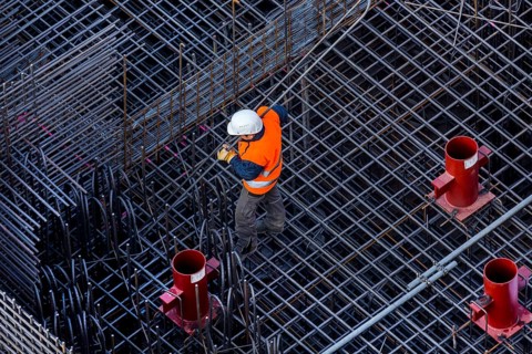 Construction workers processing reinforcing steel for reinforced concrete ceiling