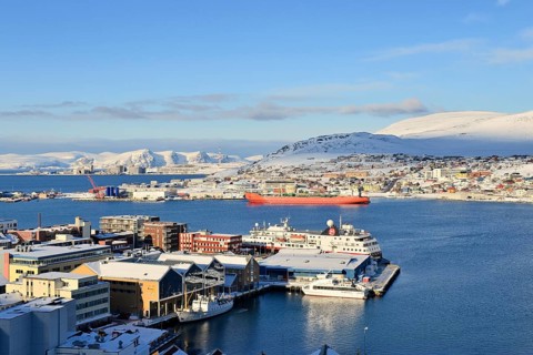 Wide bay with city and Hurtigruten dock