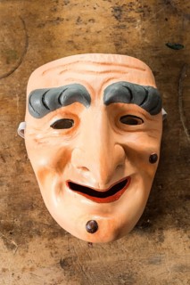 Painted wooden mask on a workbench