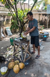 Man opening a coconut