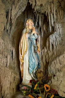 Lourdes grotto with a statue of the Virgin Mary