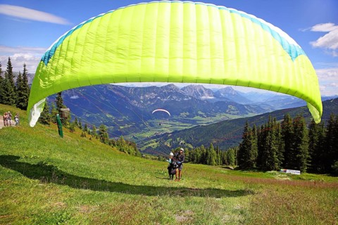 Paragliders starting a tandem jump
