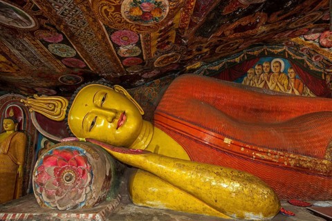 Reclining Buddha statue and painted ceilings