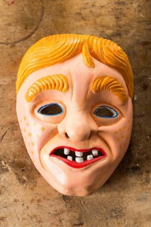 Painted wooden mask on a workbench