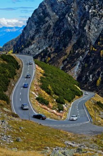 Cars on a mountain road in a hairpin curve