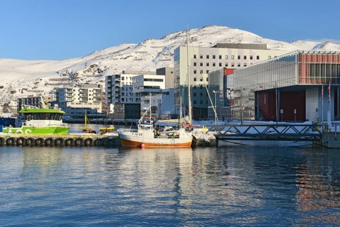 Boats and residential buildings on the shore of a bay