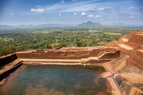 Historic rock fortress with water pool