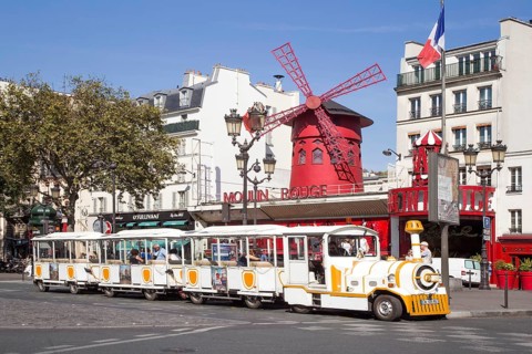 Tourist train in front of Variete Theater Moulin Rouge