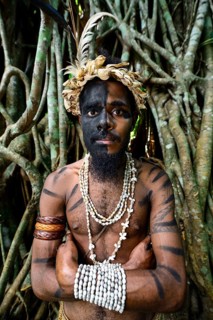Tribal warrior in front of the roots of the banyan tree