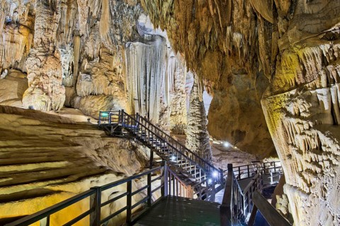 Boardwalk through illuminated dripstone cave