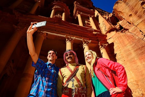 Tourists take a shot with a Bedouin Policeman at Khazne al Firaun