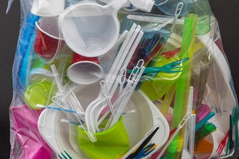 Garbage bag filled with disposable crockery