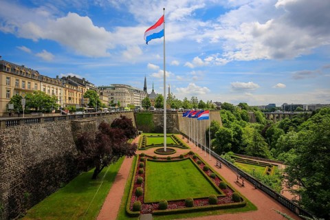 Luxembourg national flag in the park at the Place de la Constitution